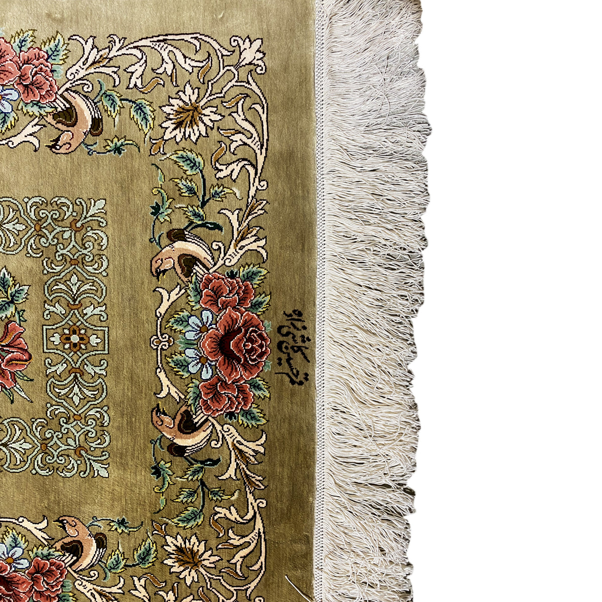 Silk carpet detail view: floral motifs in brown/green with colorful blossoms, with fringes