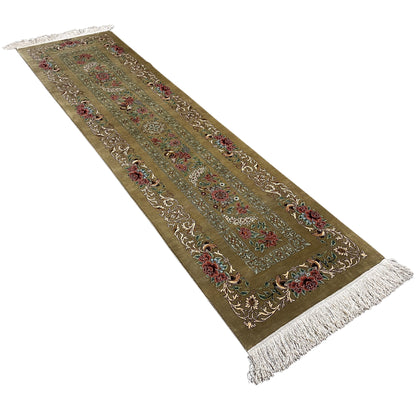 Silk carpet runner, angled: olive-colored base with an ornamental central band and fringes