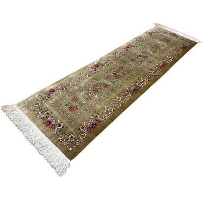 Silk runner rug with a border of flowers and ornaments, fringes at both ends