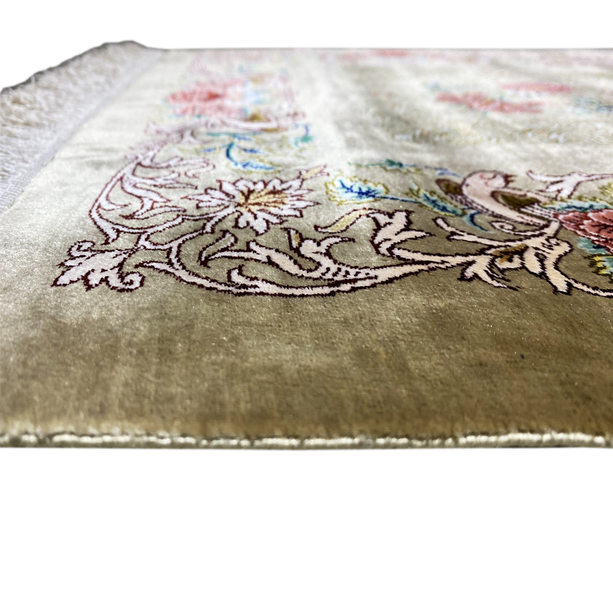 Silk carpet, close-up: delicate floral and ornamental pattern on a light olive-brown background