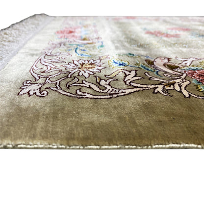 Silk carpet, close-up: delicate floral and ornamental pattern on a light olive-brown background