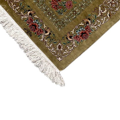 Silk carpet corner with fringes and a floral ornamental pattern on an olive-brown background