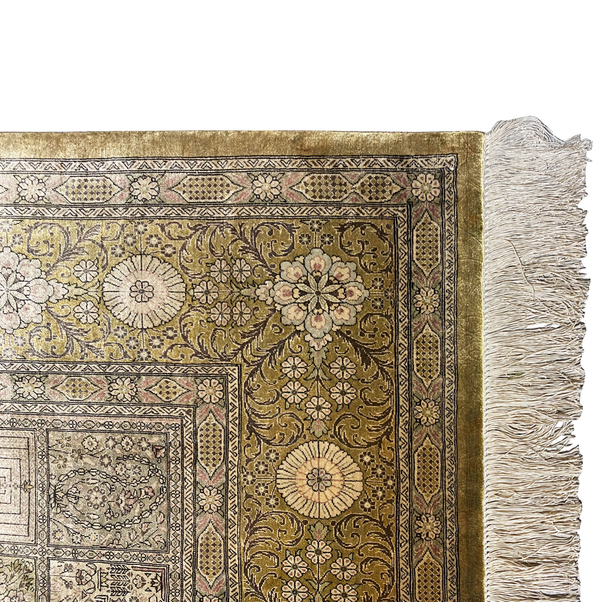 Carpet detail with large floral motifs, green and beige accents, and fringes along the edge