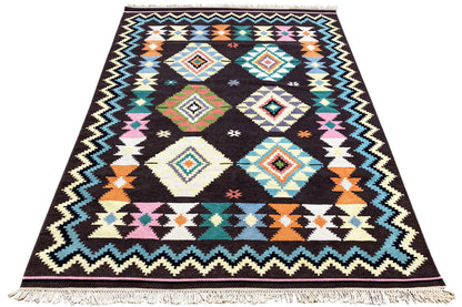 Wool rug with a multicolored diamond and zigzag pattern, fringes all around