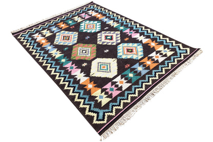 Wool rug with geometric cube and zigzag patterns, bright colors, and fringes