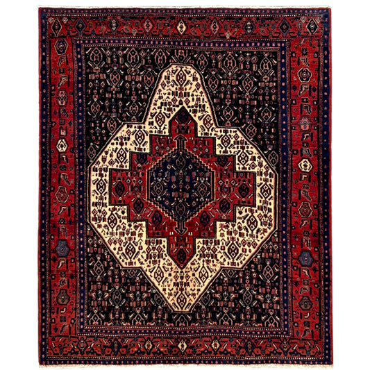 Patterned rectangular rug with a medallion in dark blue, red, and beige.