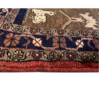 Close-up: carpet pile at the edge, border pattern, and animal motifs in brown, red, and blue