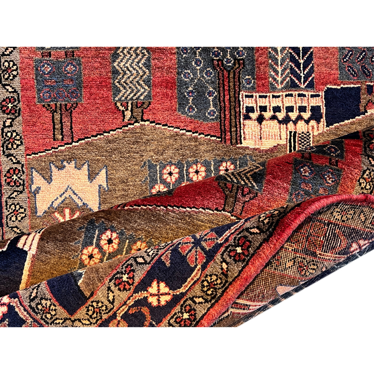 Close-up: rug with red inner fields, ornaments and animal motifs, brown and blue