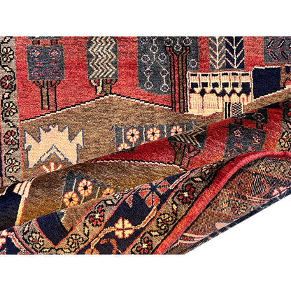 Close-up: rug with red inner fields, ornaments and animal motifs, brown and blue