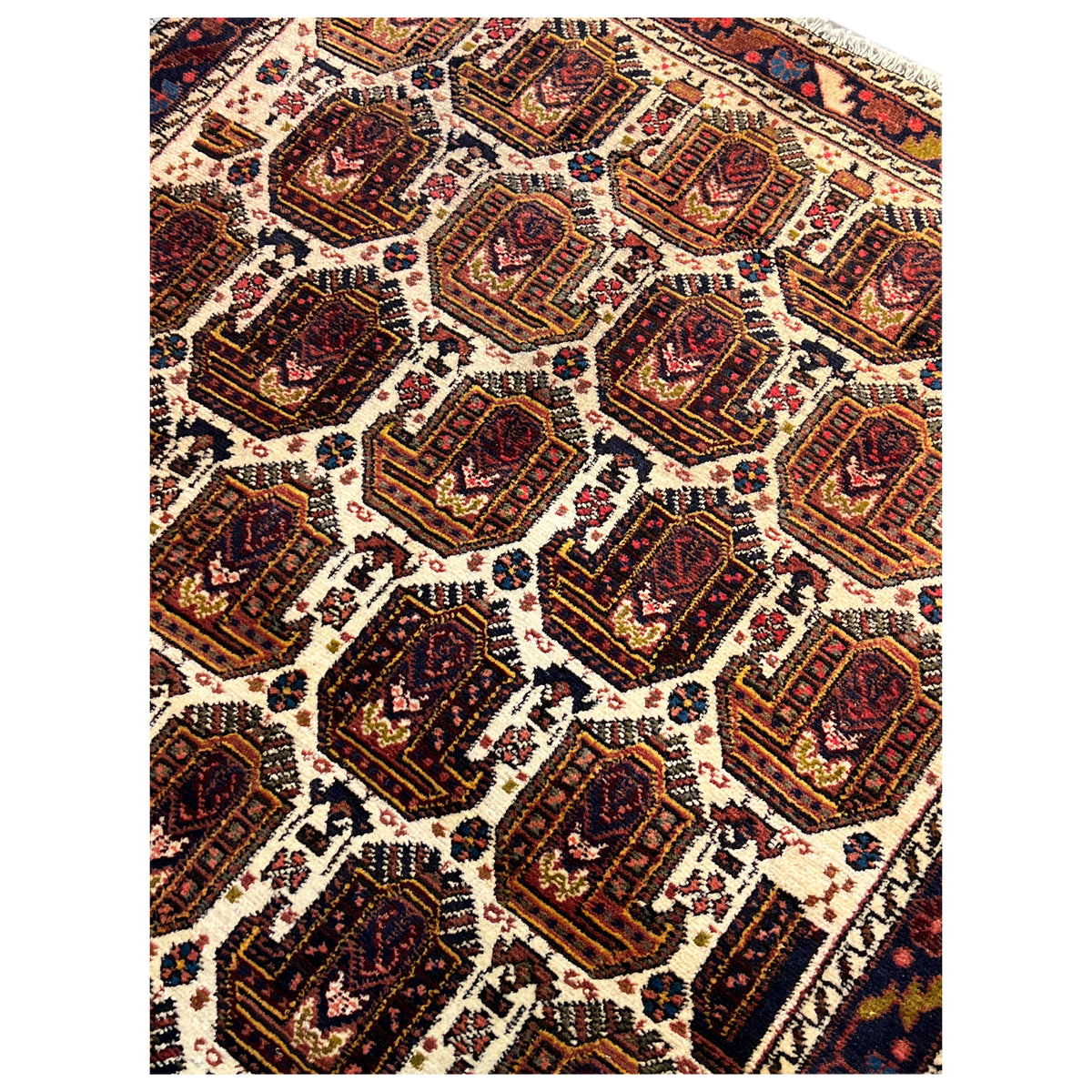 Shahre Babak carpet (154x105 cm), close-up with many dark medallions on a light background