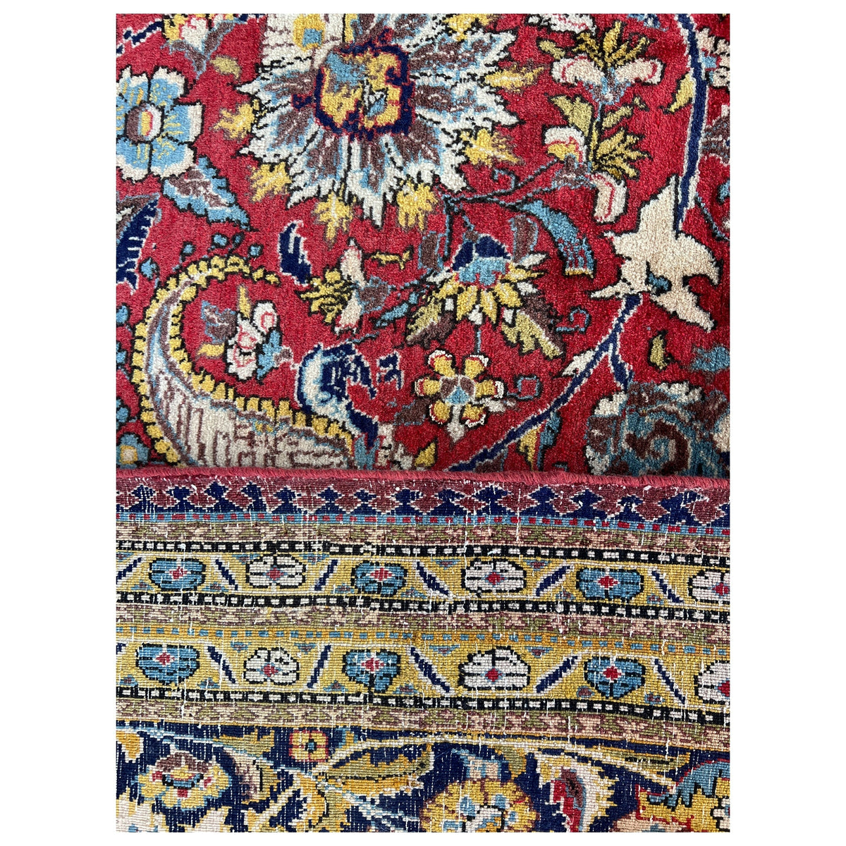 Rectangular rug with a colorful floral pattern in red, blue, and cream
