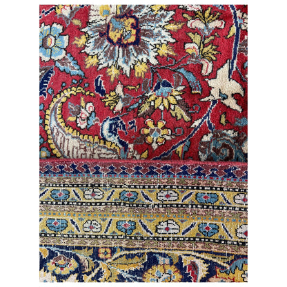 Rectangular rug with a colorful floral pattern in red, blue, and cream