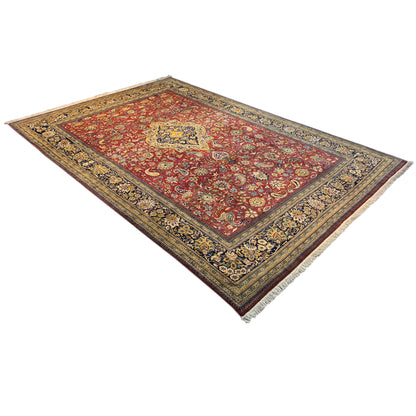 Shahreza carpet viewed from above, red pattern with a medallion and blue-and-gold borders