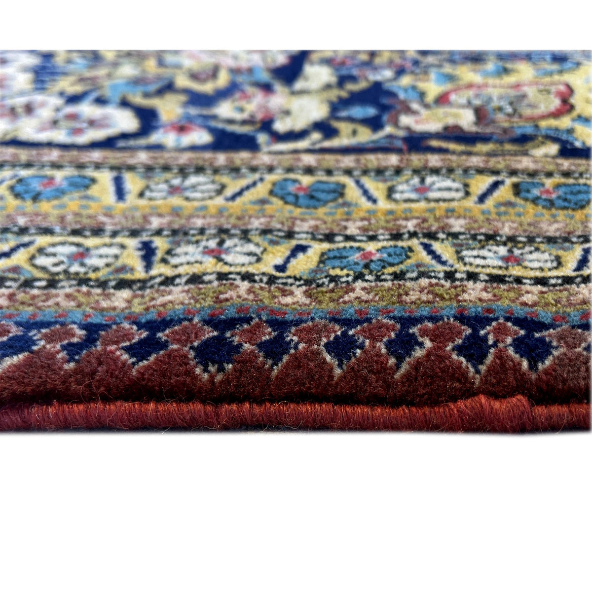 Shahreza carpet close-up: dense pile with red and blue ornaments in a zoned pattern
