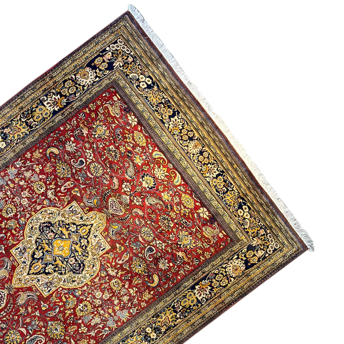 Shahreza carpet detail from an angle: red medallion in a blue-and-gold border frame