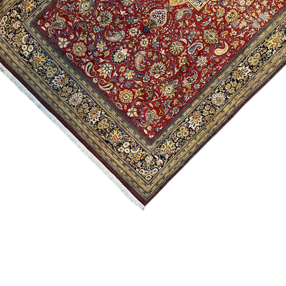Shahreza carpet corner view with a red ornamental field, blue-gold borders, and fringes
