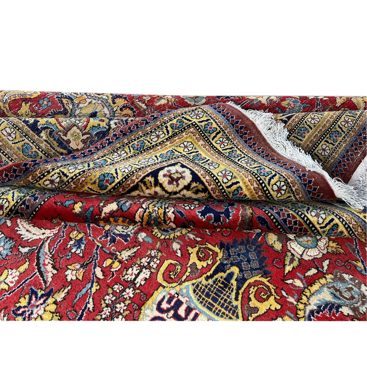 Shahreza carpet edge detail: frayed edge and colorful ornaments in blue and red