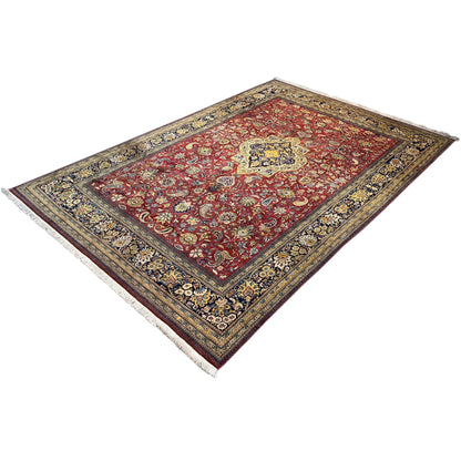 Shahreza carpet spread flat: red medallion with blue-and-gold border and fringe