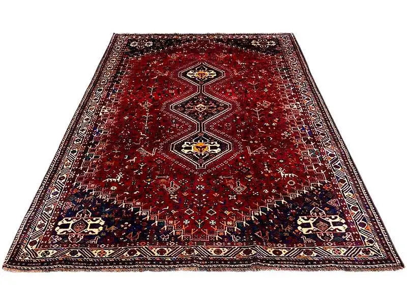 Carpet with a red background, three medallions, and a surrounding border, lying flat