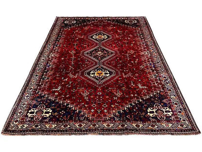 Carpet with a red background, three medallions, and a surrounding border, lying flat
