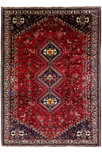 Rug with a red center, symmetrical medallions, and a dark border design
