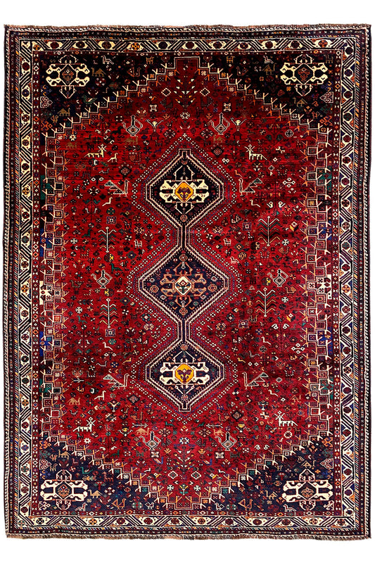 Rug with a red center, symmetrical medallions, and a dark border design
