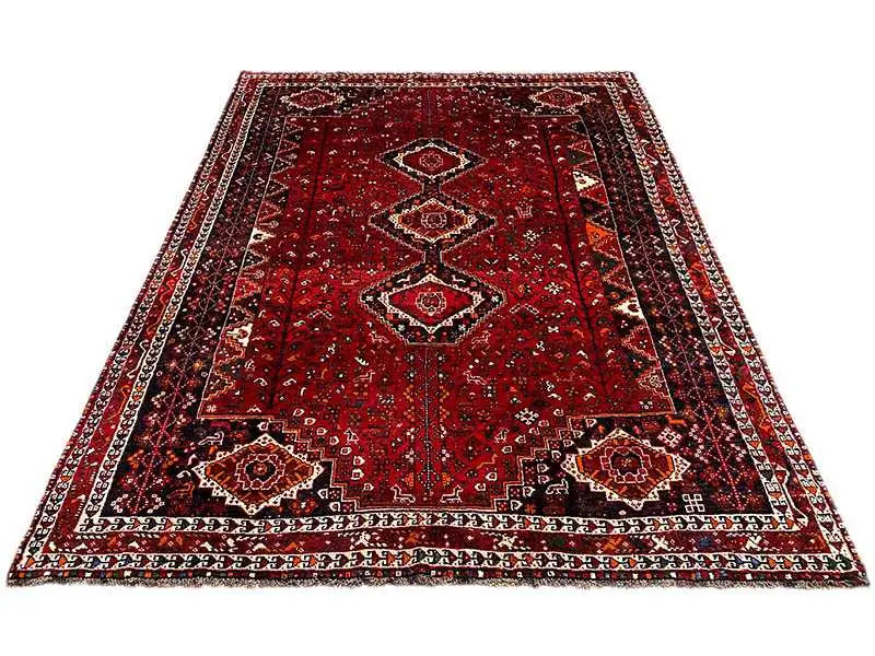 Red Oriental rug with a central field and surrounding ornamental border