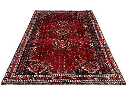 Red Oriental rug with a central field and surrounding ornamental border