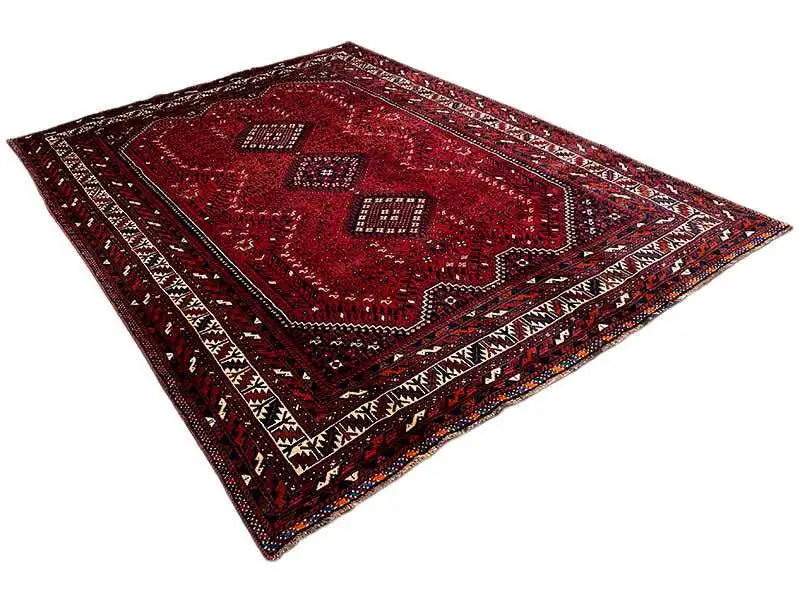 Red rug with ornamental squares, zigzag border and geometric pattern, diagonal