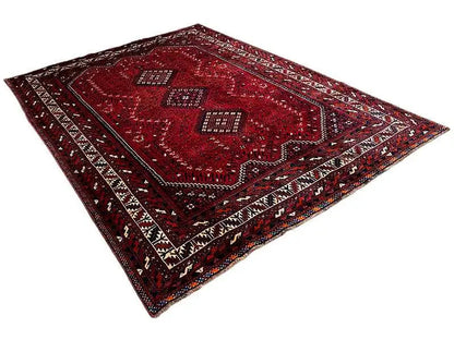 Red rug with ornamental squares, zigzag border and geometric pattern, diagonal