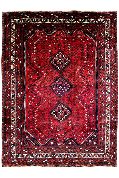 Rug with a red central medallion, surrounding border, and geometric Oriental pattern