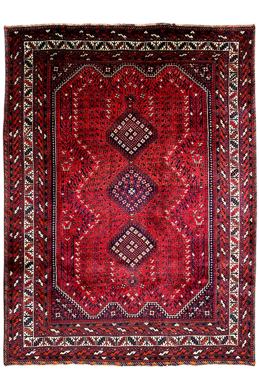 Rug with a red central medallion, surrounding border, and geometric Oriental pattern