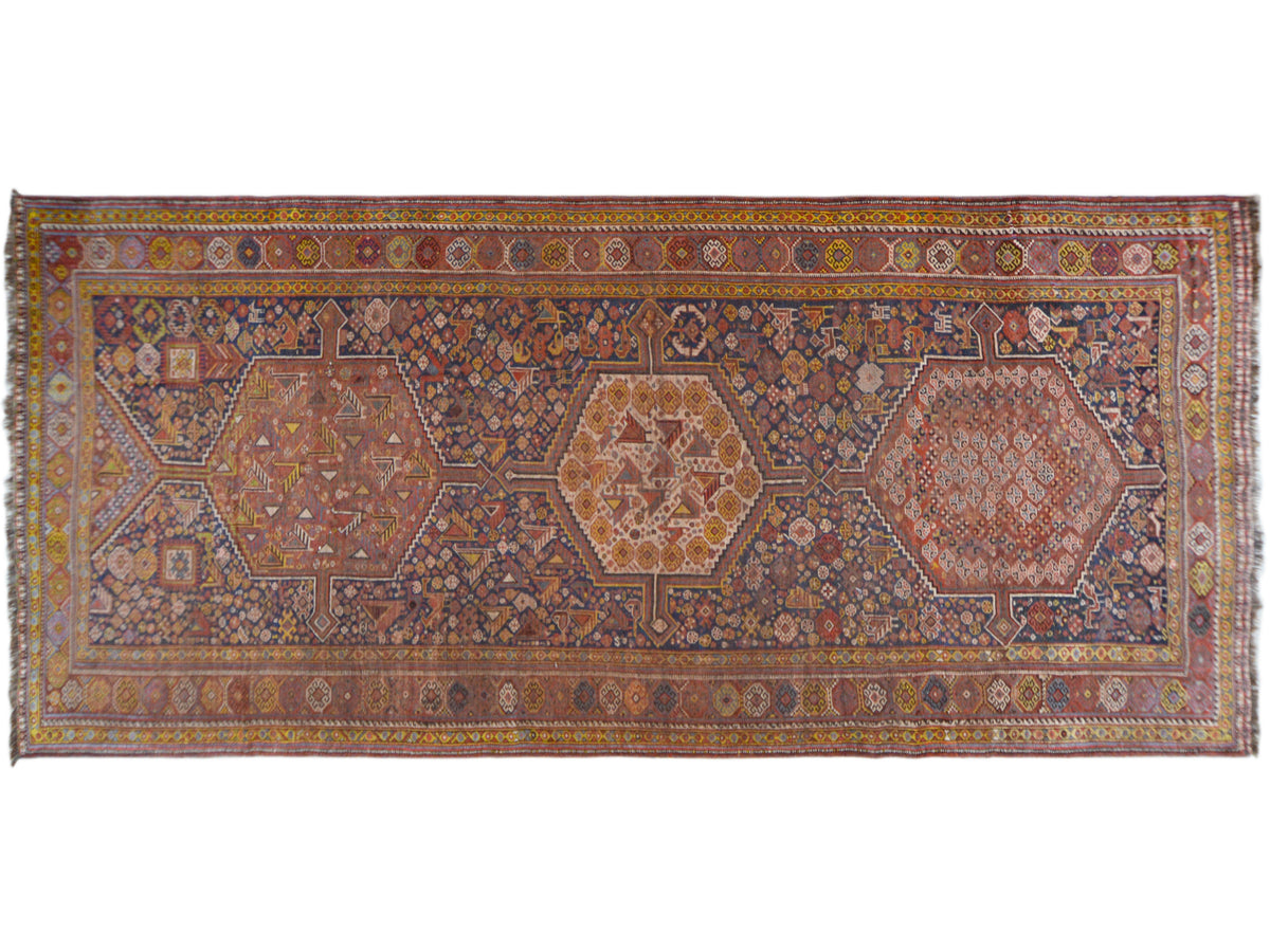 Rectangular Oriental rug with a geometric medallion pattern in blue and rust tones, 455x194 cm
