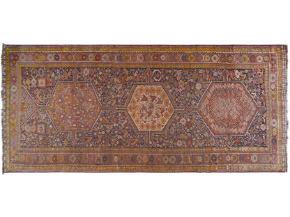 Rectangular Oriental rug with a geometric medallion pattern in blue and rust tones, 455x194 cm