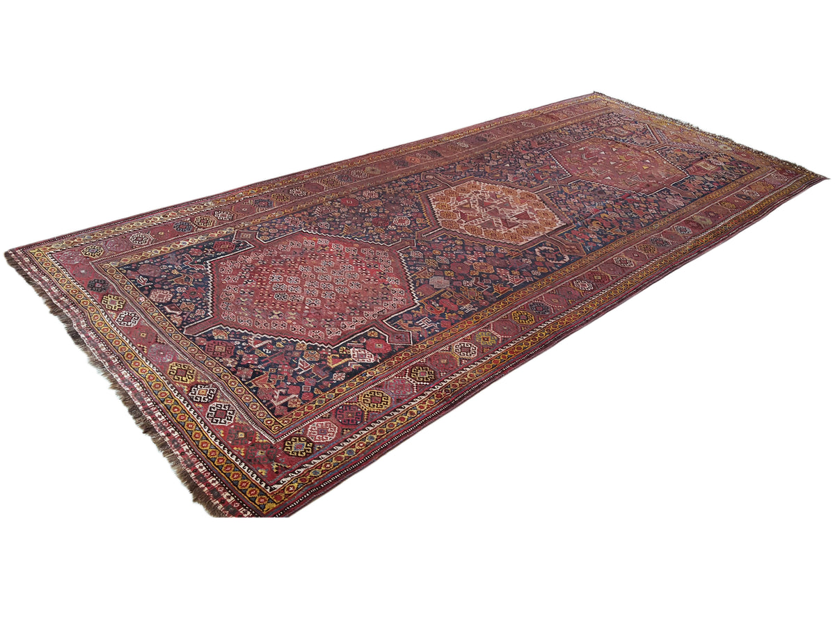 Oriental rug with patchwork patterns in rust red, blue and gold tones, 455x194 cm