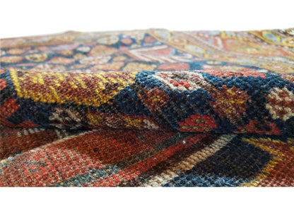 Close-up of the oriental rug: multicolored, textured weave with a subtle pile