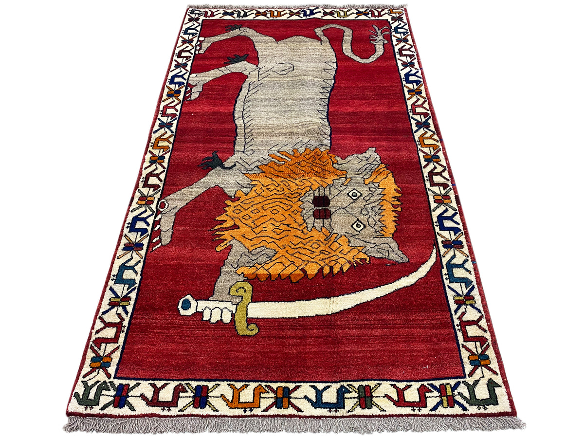 Shiraz-style rug with a red background, gray animal, and orange ornament