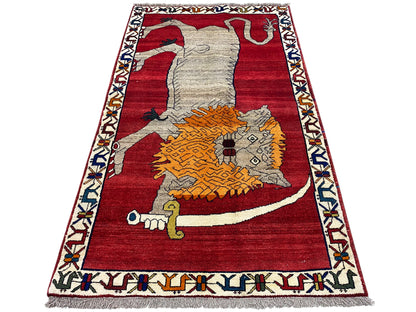 Shiraz-style rug with a red background, gray animal, and orange ornament