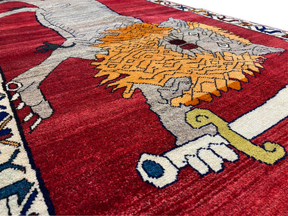 Carpet detail: gray animal and orange ornament on a red background