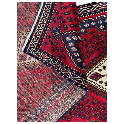 Close-up: red runner rug with an oriental pattern and contrasting border