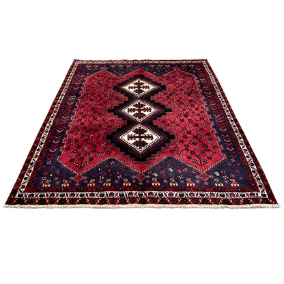 Sirjan rug, red ground with a geometric pattern and dark blue borders
