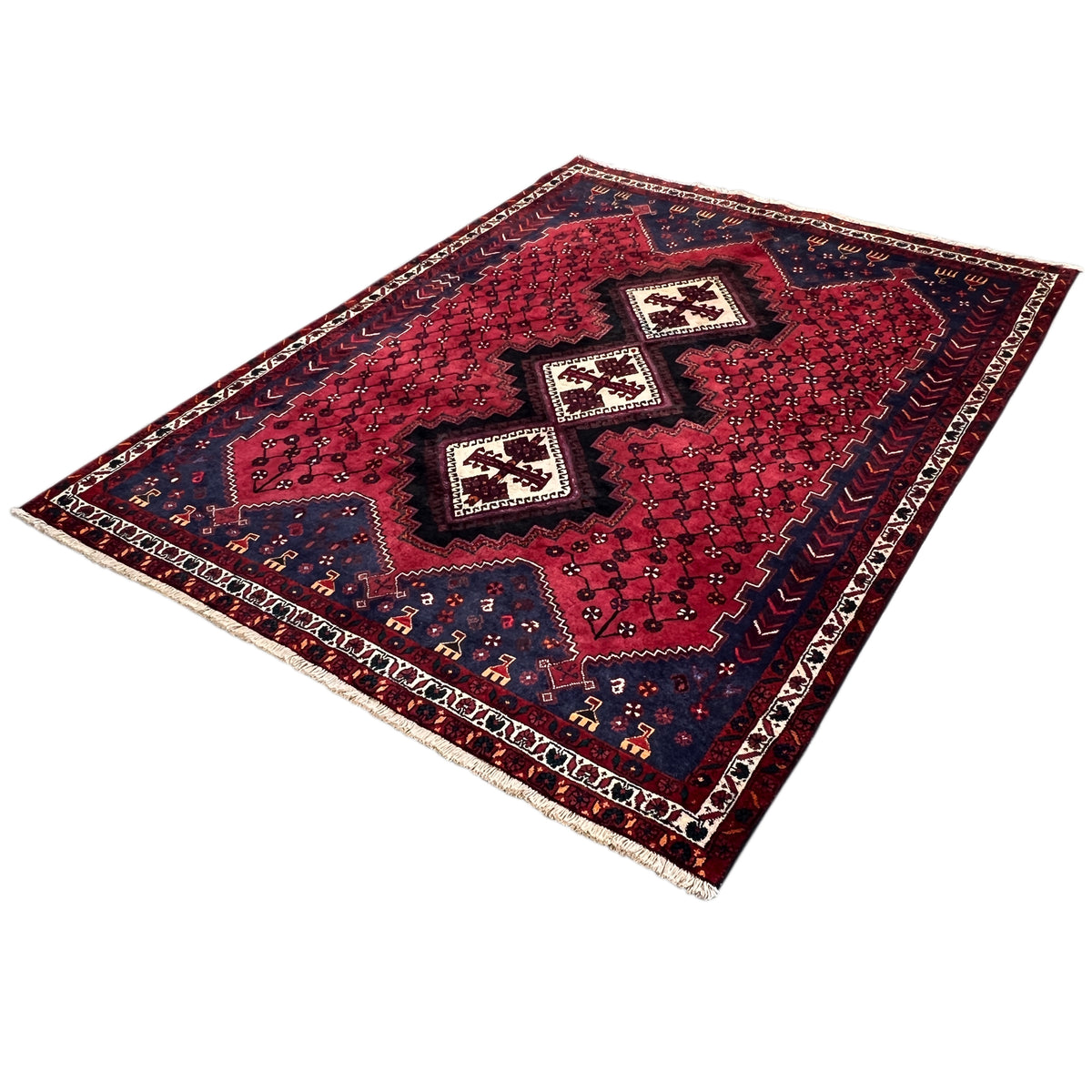 Sirjan rug with a red background, dark blue areas, and white borders