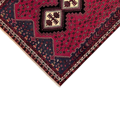 Carpet corner with a border in white and dark blue, featuring a red geometric ornament