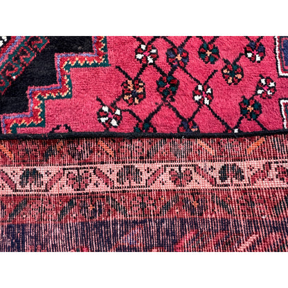 Close-up detail below: red motif with a dark area and densely textured surface