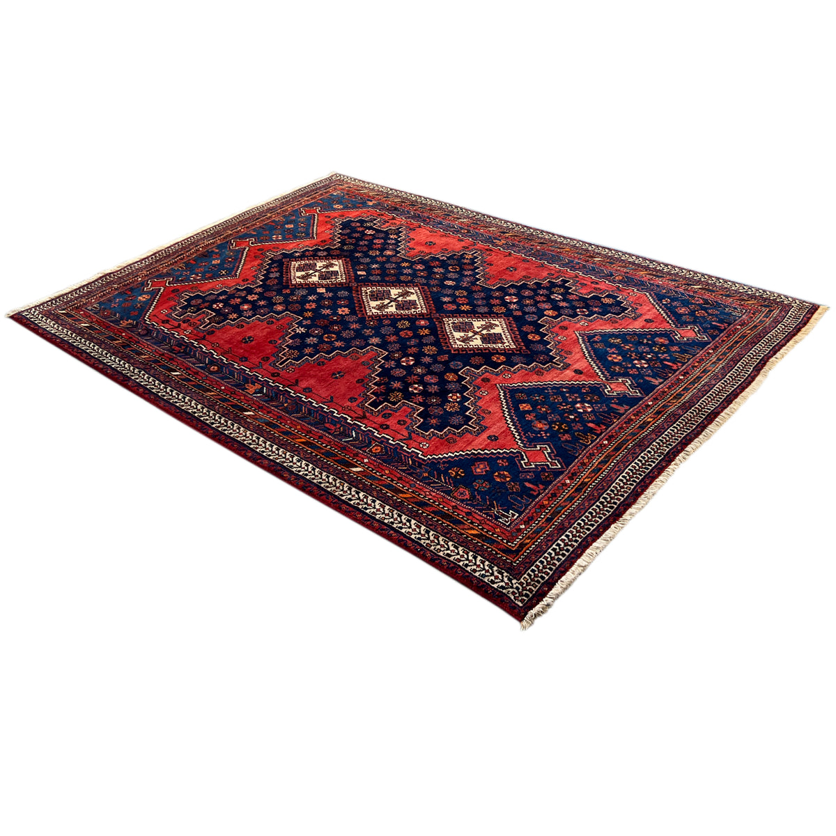 Rectangular Oriental rug with a red central field and blue border pattern