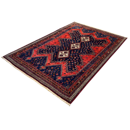 Oriental rug with a geometric pattern in red, blue, and dark brown