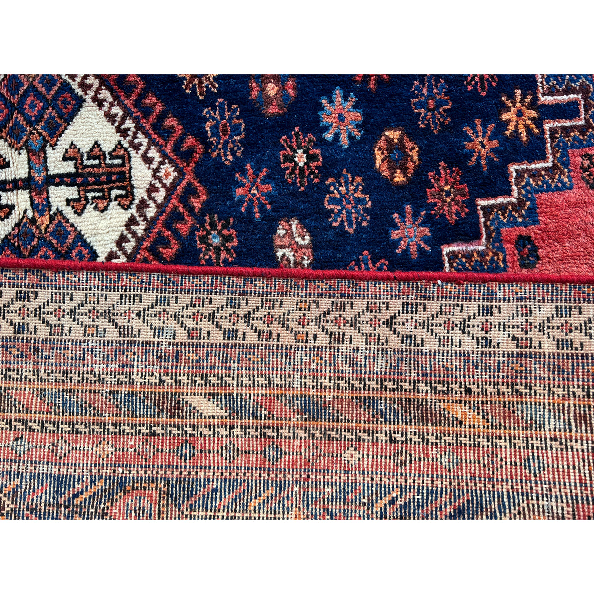 Detail view: Carpet border with colorful ornaments and multicolored weave structure