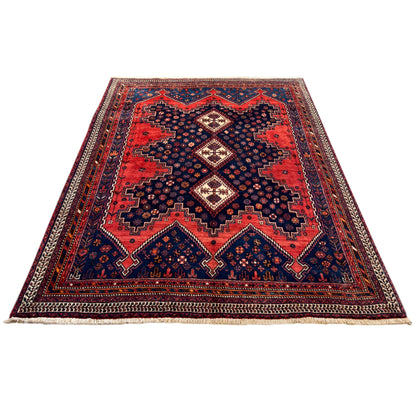 Rectangular Oriental rug with a red central medallion and blue border pattern
