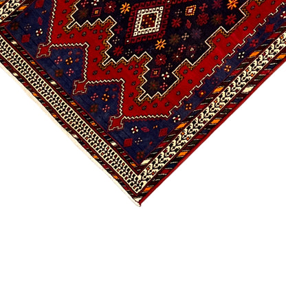 Dark blue and red runner rug with a geometric pattern and beige border