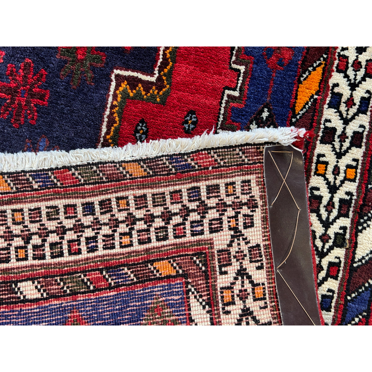 Runner rug with multicolored detailed patterns, graduated border, and short edge